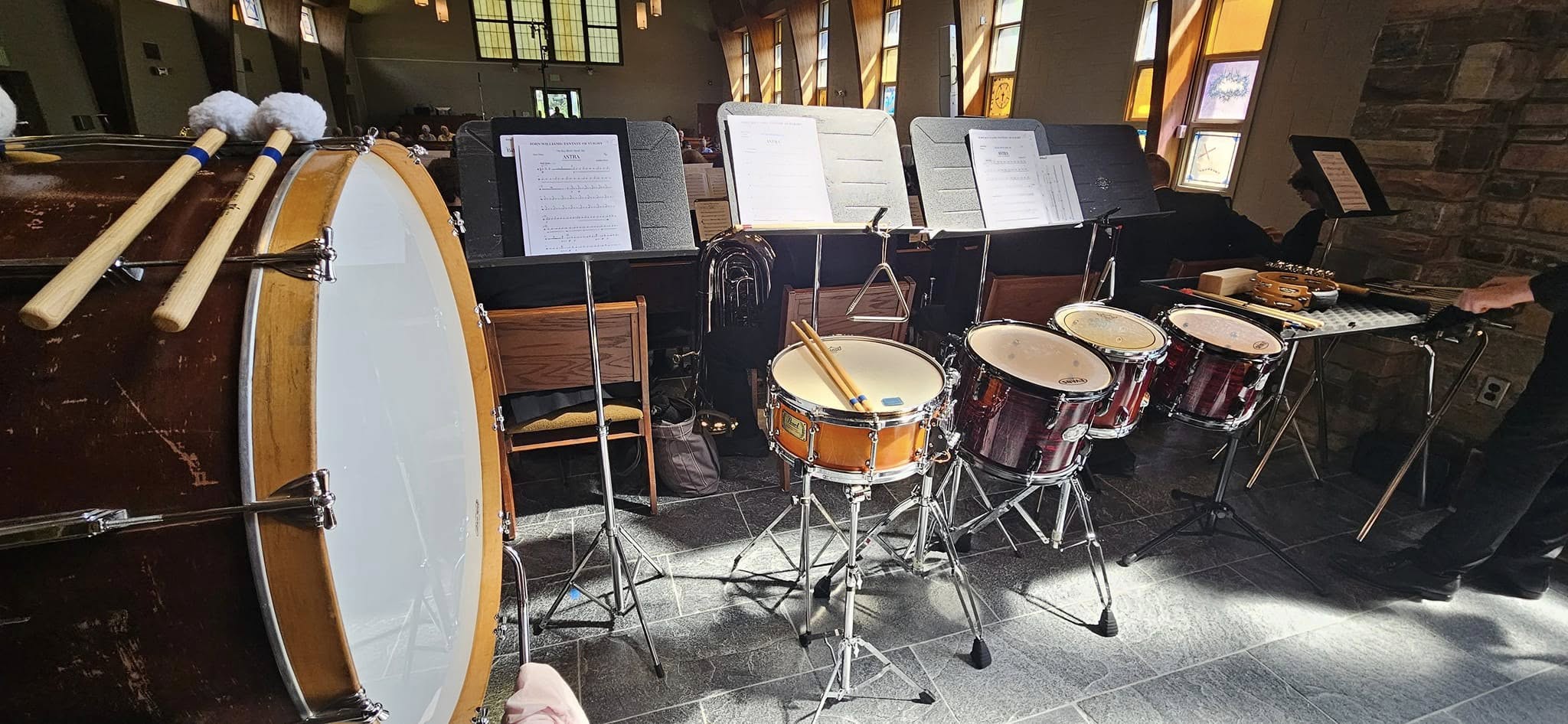 Concert percussion instruments and music stands set up for a performance