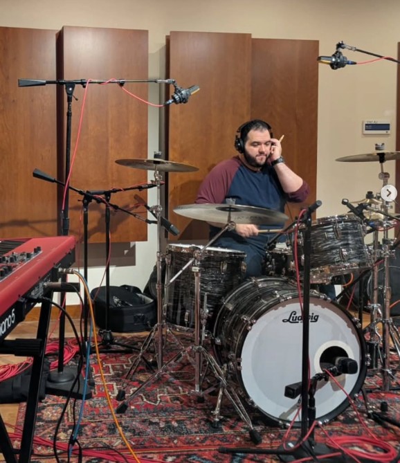 Peter Rodriguez recording drums in a studio